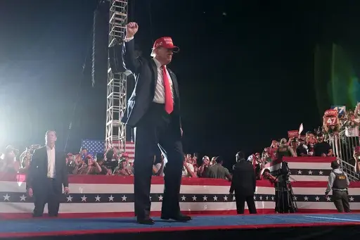 Republican presidential nominee former President Donald Trump gestures to the audience as he departs a campaign rally at the Calhoun Ranch, Saturday, Oct. 12, 2024, in Coachella, Calif. (AP Photo/Alex Brandon)