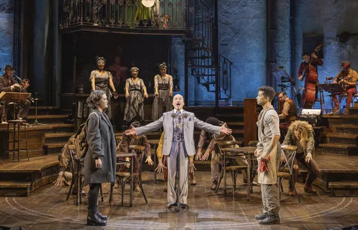 This image released by DKC/O&M shows Jon Jon Briones, center, and his daughter Isa Briones, left, and Jordan Fisher, right, and the cast during a performance of "Hadestown" in New York. (Evan Zimmerman for MurphyMade/DKC/O&M via AP)