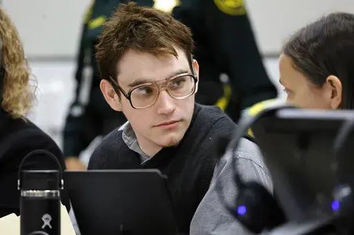 Marjory Stoneman Douglas High School shooter Nikolas Cruz is shown at the defense table during the penalty phase of his trial at the Broward County Courthouse in Fort Lauderdale, Fla., Friday, Sept. 2, 2022. Testimony at Cruz's trial shows that chaos reigned in the home he shared with his widowed mother and brother. Cruz pleaded guilty to murdering 17 students and staff members in 2018 at Marjory Stoneman Douglas High School in Parkland, Fla. The trial resumes Monday, Sept. 12, 2022. (Amy Beth B