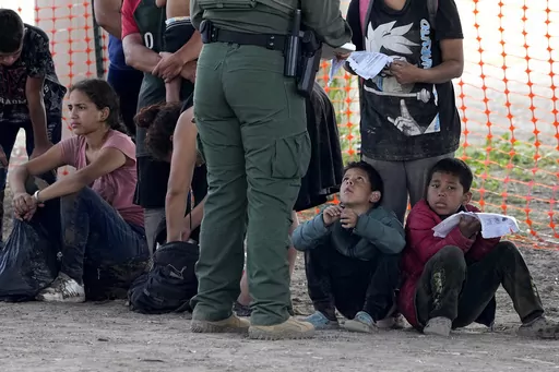 Migrants who crossed into the U.S. from Mexico wait to be processed by U.S. Border Patrol agents, Thursday, Sept. 21, 2023, in Eagle Pass, Texas. Migrants have always come to the U.S., but the immigration system now seems strained nationwide more than ever. (AP Photo/Eric Gay)