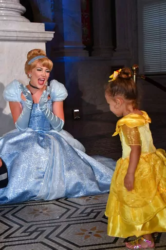 Costumed Cinderella greets a young guest at an event marking the inclusion of Disney's "Cinderella" into the National Film Registry on its 70th anniversary, June 20, 2019 at the Library of Congress in Washington. The costumed characters at the Disney parks in the U.S. have been back on the job for almost two years since the parks were temporarily shuttered due to the spread of the coronavirus. But there are a few things they haven’t been able to do during that time: Give hugs, sign autographs 