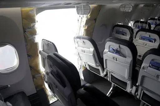 This photo released by the National Transportation Safety Board shows a gaping hole where the paneled-over door had been at the fuselage plug area of Alaska Airlines Flight 1282, Jan. 7, 2024, in Portland, Ore. The DOJ has launched a criminal investigation into the Boeing jetliner blowout that left a gaping hole on the Alaska Airlines plane this January, the Wall Street Journal reported Saturday, March 9. (National Transportation Safety Board via AP, File)