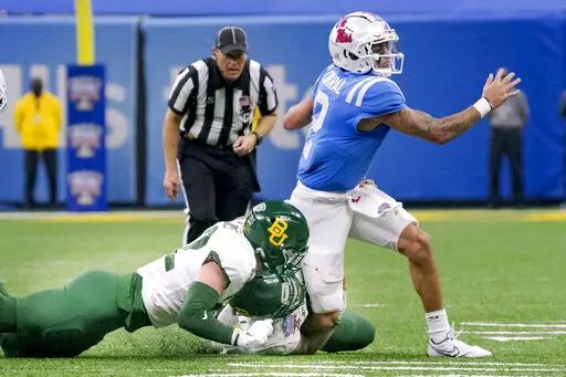 Mississippi quarterback Matt Corral (2) is tackled by Baylor defensive tackle Cole Maxwell (96) and linebacker Matt Jones (52) during the first half of the Sugar Bowl NCAA college football game in New Orleans, Saturday, Jan. 1, 2022. Corral left the field after the play. (AP Photo/Matthew Hinton)