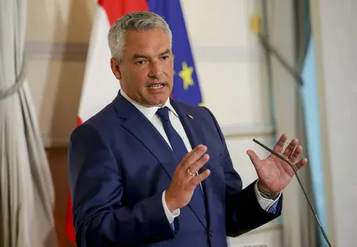 Austrian Chancellor Karl Nehammer attends a press conference in Vienna on Thursday, Aug. 8, 2024. (AP Photo/Heinz-Peter Bader, File)