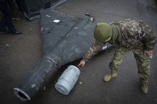 A Ukrainian officer shows a thermobaric charge of a downed Shahed drone launched by Russia in a research laboratory in an undisclosed location in Ukraine Thursday, Nov. 14, 2024. (AP Photo/Efrem Lukatsky)