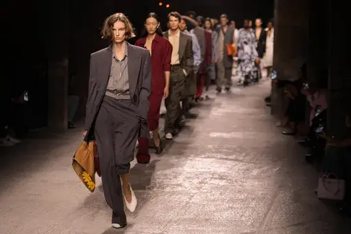 Models wear creations as part of the Bottega Veneta Spring Summer 2025 collection, that was presented in Milan, Italy, Saturday, Sept. 21, 2024. (AP Photo/Luca Bruno, File)