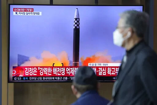 People watch a TV screen showing a news program reporting about North Korea's ICBM at a train station in Seoul, South Korea, Friday, March 25, 2022. North Korea said Friday it test-fired its biggest-yet intercontinental ballistic missile under the orders of leader Kim Jong Un, who vowed to expand the North's "nuclear war deterrent" while preparing for a "long-standing confrontation" with the United States. (AP Photo/Lee Jin-man)