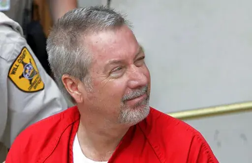 In this May 8, 2009, file photo, former Bolingbrook, Ill., police Sgt. Drew Peterson leaves the Will County Courthouse in Joliet, Ill., after his arraignment on charges of first-degree murder in the 2004 death of his third wife Kathleen Savio. On Monday, Feb. 7, 2022, Peterson's legal team is scheduled to ask a judge to vacate his 2012 conviction in the murder of Savio. (AP Photo/M. Spencer Green, File)