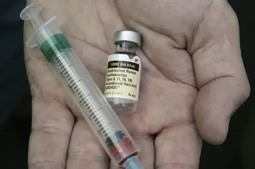 A doctor holds a vial of the human papillomavirus (HPV) vaccine Gardasil in Chicago on Aug. 28, 2006. (AP Photo/Charles Rex Arbogast, File)