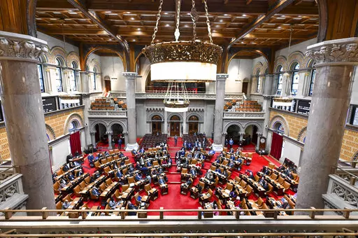 Members of the New York Assembly debate legislation to approve a legislative pay raise during a special legislative session in the Assembly Chamber at the state Capitol in Albany, N.Y., Dec. 22, 2022. New York lawmakers are now the highest paid legislators in the nation under a bill signed Saturday, Dec. 31. Members of both houses will make a base salary of $142,000 starting Sunday, Jan. 1, 2023, under the pay raise bill they passed during a special session in late December. (AP Photo/Hans Penni