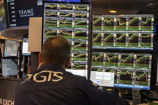 A specialist studies monitors on the New York Stock Exchange trading floor in New York on November 21, 2024. (AP Photo/Ted Shaffrey, File)