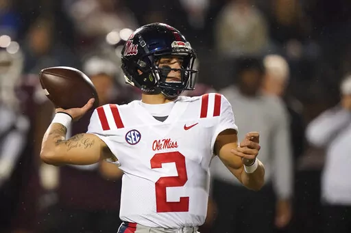 FILE - Mississippi quarterback Matt Corral (2) passes against Mississippi State during the first half of an NCAA college football game, Thursday, Nov. 25, 2021, in Starkville, Miss.  The Southeastern Conference's most prolific offense clashes with one of the better defenses in the Big 12 when No. 8 Mississippi meets sixth-ranked Baylor in the Sugar Bowl. (AP Photo/Rogelio V. Solis, File)