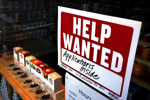 A help-wanted sign hangs in the front window of the Bar Harbor Tea Room, Saturday, June 11, 2022, in Bar Harbor, Maine. On Thursday, the Labor Department reports on the number of people who applied for unemployment benefits last week. (AP Photo/Robert F. Bukaty, File)
