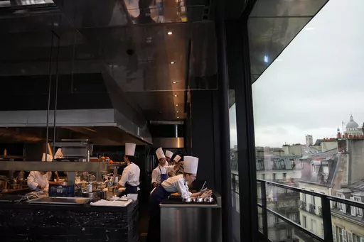Cooks prepare food at La Tour d'Argent restaurant in Paris, Wednesday, Dec. 13, 2023. The Tour d'Argent, which claims to be the oldest restaurant in the French capital, has a front-row view of the renaissance of Notre Dame Cathedral as artisans prepare the fire-ravaged monument for reopening next year. The high-end restaurant, which helped inspire the movie "Ratatouille,'' recently reopened after its own renovation that preserved traditions while adapting to the 21st century. It will also overlo