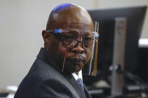 Accused serial killer Billy Chemirmir looks back ahead of his third trial at Frank Crowley Courts Building, Oct. 3, 2022, in Dallas. Chemirmir, who was accused of killing nearly two dozen older women and convicted in 2022 in the slayings of two, was killed Tuesday morning, Sept. 19, 2023, by his cellmate at a Texas prison, an official said. (Shafkat Anowar/The Dallas Morning News via AP, File)