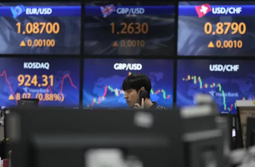 A currency trader talks on the phone at the foreign exchange dealing room of the KEB Hana Bank headquarters in Seoul, South Korea, Wednesday, Aug. 30, 2023. Asian shares rose Wednesday, boosted by a Wall Street rally that came on positive reports on consumer confidence and job openings.(AP Photo/Ahn Young-joon)