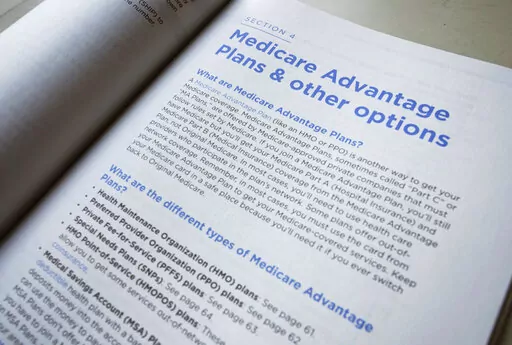 This Nov. 8, 2018 file photo shows a page from the 2019 U.S. Medicare Handbook in Washington. In 2022, 48% of Medicare beneficiaries were enrolled in Medicare Advantage plans instead of original Medicare, and experts predict the number will be higher in 2023. Medicare Advantage plans are offered by private insurers and bundle Medicare benefits in a way many people find appealing — but they also limit care to network providers, often require preapproval to see specialists and can saddle benefic