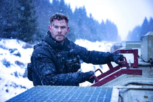 This image released by Netflix shows Chris Hemsworth as Tyler Rake in a scene from the film "Extraction 2." (Jason Boland/Netflix via AP)