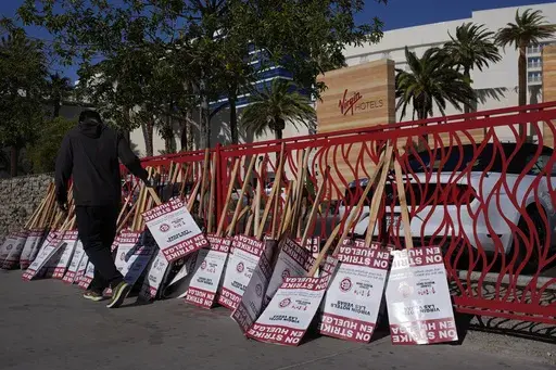A members of the Culinary Workers Union holds a picket sign outside the Virgin Hotels Las Vegas, Nov. 15, 2024, in Las Vegas. (AP Photo/John Locher, File)