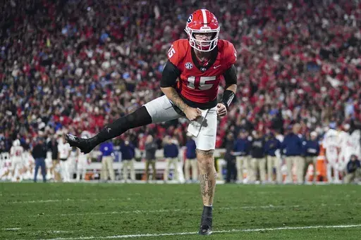 Georgia quarterback Carson Beck (15) reacts after a touchdown against Mississippi during the first half of an NCAA college football game, Saturday, Nov. 11, 2023, in Athens, Ga. (AP Photo/John Bazemore, File)
