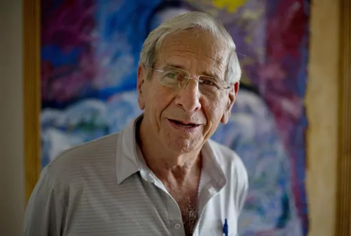 Israeli actor Chaim Topol speaks during an interview in Tel Aviv, Israel, on April 8, 2015. Chaim Topol, a leading Israeli actor who charmed generations of theatergoers and movie-watchers with his portrayal of Tevye, the long-suffering and charismatic milkman in “Fiddler on the Roof,” has died in Tel Aviv, Israeli leaders said Thursday, March 9, 2023. He was 87. (AP Photo/Ariel Schalit, File)