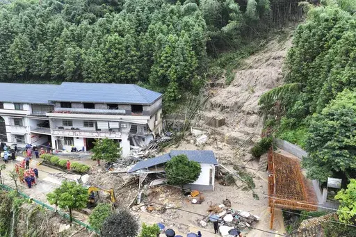 In this drone photo released by Xinhua News Agency, a landslide destroys a house in Yuelin village of Shouyue town of Hengyang city, central China's Hunan Province on Sunday, July 28, 2024. (Chen Zhenhai/Xinhua via AP)