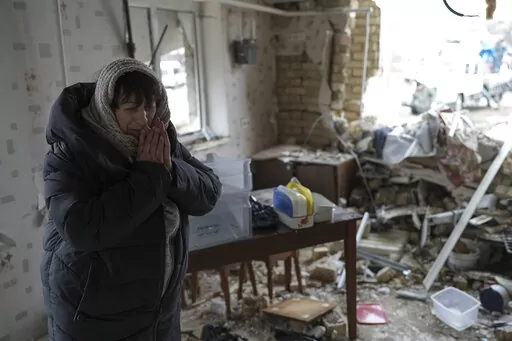 Halina Panasian, 69, reacts inside her destroyed house after a Russian rocket attack in Hlevakha, Kyiv region, Ukraine, Thursday, Jan. 26, 2023. (AP Photo/Roman Hrytsyna)