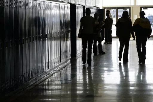Students walk down a hallway at a high school in Iowa on Tuesday, Dec. 19, 2006. In 2024, bills in the Iowa, Kentucky, Missouri and West Virginia legislatures would require public school students to watch a fetal development video similar to one created by an anti-abortion group. The proposed legislation mirrors a law passed in North Dakota last year. (Scott Morgan/The Hawk Eye via AP)
