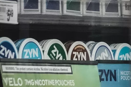 Containers of Zyn, a Phillip Morris smokeless nicotine pouch, are displayed for sale among other nicotine and tobacco products at a newsstand Friday, Feb. 23, 2024, in New York. The product has been making big headlines, sparking debate about whether new nicotine-based alternatives intended for adults may be catching on with underage teens and adolescents. (AP Photo/Bebeto Matthews, File)