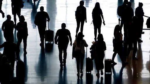 People pass through Salt Lake City International Airport Monday, June 27, 2022, in Salt Lake City. To avoid overpaying for travel, customers should beware of hidden fees that airlines, hotels and vacation rentals can add onto the initial booking price. Travel companies use a method called “drip pricing” to get customers to pay more. Hotel resort fees are one of the most egregious examples that usually aren’t shown as part of the nightly rate. Travelers can avoid some fees by skipping or de