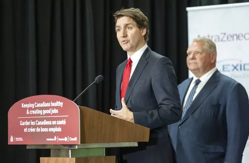 Canadian Prime Minister Justin Trudeau answers questions at an announcement in Mississauga, Ontario, Monday, Feb. 27, 2023. Canada announced Monday it is banning TikTok from all government-issued mobile devices, reflecting widening worries from Western officials over the Chinese-owned video sharing app. Trudeau said it might be a first step to further action. Ontario Premier Doug Ford is at right. (Frank Gunn/The Canadian Press via AP)