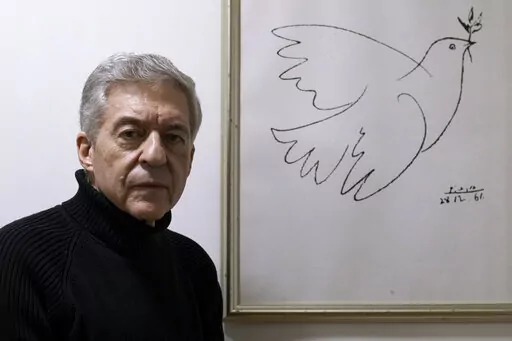 Yossi Beilin, a former senior Israeli official and peace negotiator who co-founded the Geneva Initiative, poses for a photo at his house in Tel Aviv, Israel, Sunday, Feb. 6, 2022. Israeli and Palestinian public figures, including Beilin and Hiba Husseini, a former legal advisor to the Palestinian negotiating team who hails from a prominent Jerusalem family, have drawn up a new proposal for a two-state confederation that they hope will offer a way forward after a decade-long stalemate in Mideast 