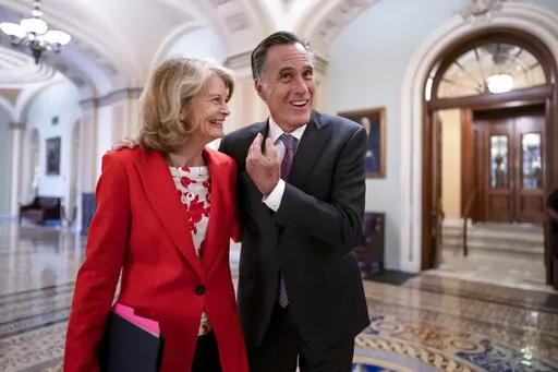 Republican Senators Lisa Murkowski of Alaska, left, and Mitt Romney of Utah, who say they will vote to confirm Judge Ketanji Brown Jackson's historic nomination to the Supreme Court, smile as they greet each other outside the chamber, at the Capitol in Washington, Tuesday, April 5, 2022. Murkowski and Romney join Sen. Susan Collins, R-Maine, who is also bucking the GOP leadership in giving President Joe Biden's nominee a new burst of bipartisan support to become the first Black woman on the high
