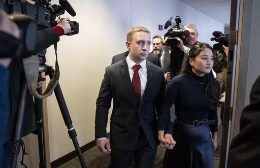 Trooper Ryan Londregan walks hand-in-hand with his wife to his first court appearance to answer to murder and manslaughter charges in the killing of Ricky Cobb II during a traffic stop last summer, Jan. 29, 2024, at the Hennepin Public Safety Facility in Minneapolis. Prosecutors plan to dismiss murder and manslaughter charges against Londregan, who fatally shot Cobb as he tried to pull away from a traffic stop, saying the unexpected decision comes in response to recent statements from the troope