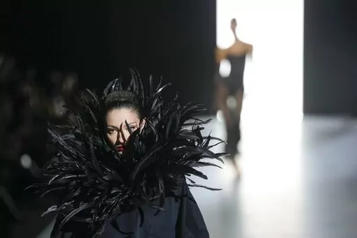 A model wears a creation as part of the Dolce & Gabbana women's Fall-Winter 2023-24 collection presented in Milan, Italy, Saturday, Feb. 25, 2023. (AP Photo/Antonio Calanni)