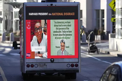 A truck with electronic panels drives along a street Tuesday, Dec. 12, 2023, near Harvard University, in Cambridge, Mass. The truck displays messages calling attention to a recent controversy involving testimony to Congress by presidents of three prestigious schools, including Harvard University, MIT, and the University of Pennsylvania. Harvard's highest governing body announced Tuesday that President Claudine Gay will remain leader of Harvard following her comments last week at a congressional 