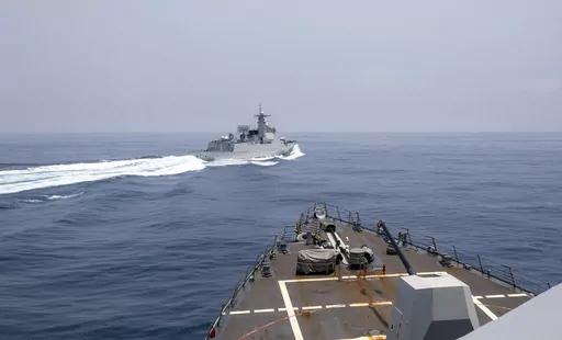 In this photo provided by the U.S. Navy, the USS Chung-Hoon observes a Chinese navy ship conduct what it called an "unsafe” Chinese maneuver in the Taiwan Strait, Saturday, June 3, 2023, in which the Chinese navy ship cut sharply across the path of the American destroyer, forcing the U.S. ship to slow to avoid a collision. The incident occurred as the American destroyer and Canadian frigate HMCS Montreal were conducting a so-called “freedom of navigation” transit of the strait between Taiw