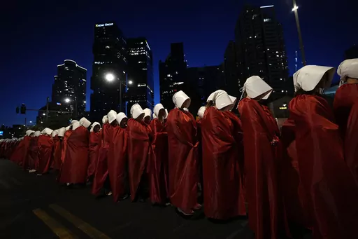 Israeli women's rights activists dressed as characters in the popular television series, "The Handmaid's Tale," protest plans by Prime Minister Benjamin Netanyahu's government to overhaul the judicial system, in Tel Aviv, Israel, Saturday, March 11, 2023. (AP Photo/Ohad Zwigenberg, File)