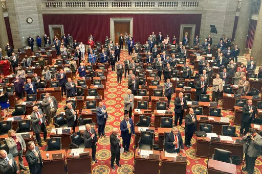 Members of the Missouri House of Representatives recite the Pledge of Allegiance as they begin their annual legislative session, Jan. 5, 2022, in Jefferson City, Mo. Women who serve in the Missouri House will face a tougher dress code when they return to the floor this week after a debate that Democrats panned as a pointless distraction from the issues facing the state. The new rules require female legislators and staff members to wear a jacket such as a cardigan or blazer. The Republican lawmak