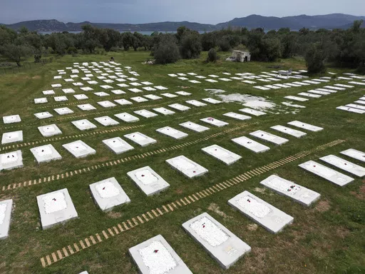 A cemetery is seen from above at Kato Tritos village on the northeastern Aegean Sea island of Lesbos, Greece, on Wednesday, April 17, 2024. After years of neglect, a primitive burial ground for refugees who died trying to reach Greece's island of Lesbos has been cleaned up and redesigned to provide a dignified resting place for the dead. (AP Photo/Panagiotis Balaskas)