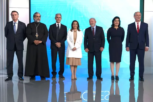 From left, Brazil's President Jair Bolsonaro, who is running for re-election, Padre Kelmon of the Brazilian Labour Party, Felipe D'Avila of the Novo Party, Soraya Thronicke of the Brasil Union Party, former president and now presidential candidate Luiz Inacio "Lula" da Silva of the Workers' Party, Simone Tebet of the Brazilian Democratic Movement Party, and Ciro Gomes of the Democratic Labour Party, arrive to participate in a presidential debate in Rio de Janeiro, Brazil, Thursday, Sept. 29, 202