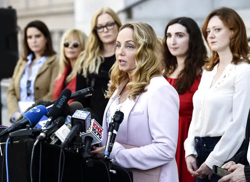 Actress Louisette Geiss speaks at a news conference by the "Silence Breakers," a group of women who have spoken out about Hollywood producer Harvey Weinstein's sexual misconduct, at Los Angeles City Hall, on Feb. 25, 2020, in Los Angeles. Geiss, a former actress and screenwriter who accused Weinstein in 2017, has written a musical stemming from her experiences with Weinstein. “The Right Girl,” which was waylaid by the pandemic but will be produced live onstage sometime in 2023. (AP Photo/Chr
