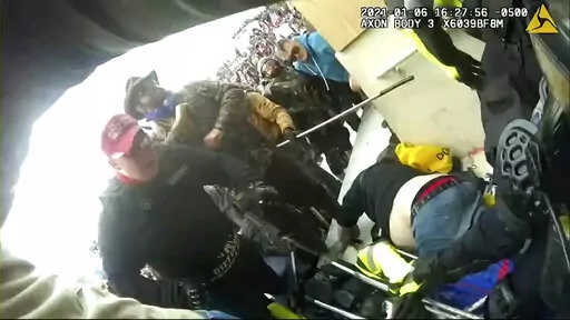 This exhibit from video released by the House Select Committee, shows an image from police-worn body camera of rioters at the Capitol on Jan 6, displayed at a hearing by the House select committee investigating the Jan. 6 attack on the U.S. Capitol, July 21, 2022, on Capitol Hill in Washington. House Speaker Kevin McCarthy is defending his decision to give Fox News' Tucker Carlson "exclusive" access to Jan. 6 security footage of the Capitol attack, despite the conservative commentator's own work