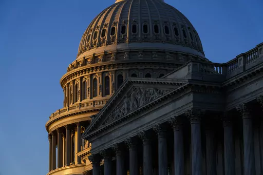 The rising sun illuminates the U.S. Capitol, Dec. 19, 2022 in Washington. A new poll finds that most U.S. adults say they are highly concerned about the impact on the national economy if the U.S. debt limit is not increased and the government defaults on its loans. That's according to a survey from The Associated Press-NORC Center for Public Affairs Research. (AP Photo/Matt Rourke, File)