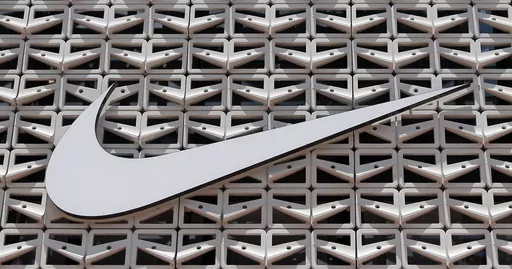 The Nike logo is shown on a store in Miami Beach, Fla. on Aug. 8, 2017. An agreement to weed out global tax havens and force multinational corporations, among them Apple and Nike, to pay a minimum tax has been weakened by loopholes and will raise only a fraction of the revenue that was envisioned, a tax watchdog backed by the European Union has warned. (AP Photo/Alan Diaz, File)