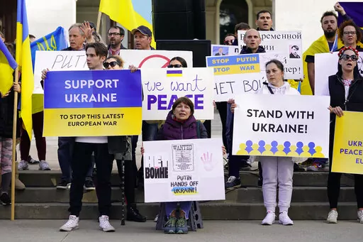 FILE— Members of the Ukrainian community and others gathered at the state Capitol to protest the Russian invasion of Ukraine at a rally n Sacramento, Calif., Thursday, Feb. 24, 2022. Roughly 18,000 Ukrainians live in the Sacramento region and the area is preparing for the possibility of many more Ukrainians arriving after U.S. President Joe Biden announced the nation will accept up to 100,000 refugees from the country. (AP Photo/Rich Pedroncelli, File)