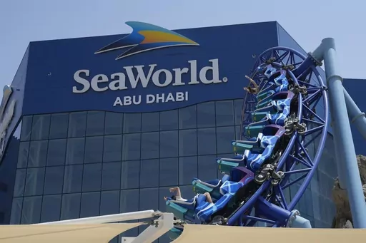 People enjoy riding on a roller coaster at the SeaWorld on Yas Island in Abu Dhabi, United Arab Emirates, on May 26, 2023. It’s the first venture outside the United States for the theme park chain, which had been mired in controversy in recent years over the treatment of captive killer whales. The $1.2 billion Abu Dhabi venture with state-owned developer Miral features the world's largest aquarium and cylindrical LED screen, as well as state-of-the-art facilities housing dolphins, seals, and o