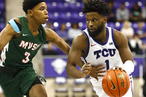 TCU guard Mike Miles Jr. (1) handles the ball as Mississippi Valley State guard Kadar Waller (3) defends during the second half of an NCAA college basketball game, Sunday, Dec. 18, 2022, in Fort Worth, Texas. (AP Photo/Ron Jenkins)