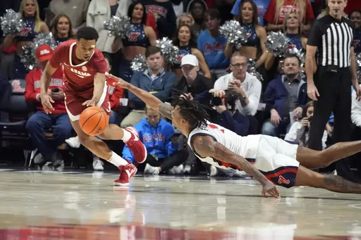 Mississippi guard Allen Flanigan (7) reaches for a loose ball that Alabama guard Rylan Griffen (3) scoops up during the second half of an NCAA college basketball game, Wednesday, Feb. 28, 2024, in Oxford, Miss. Alabama won 103-88. (AP Photo/Rogelio V. Solis)