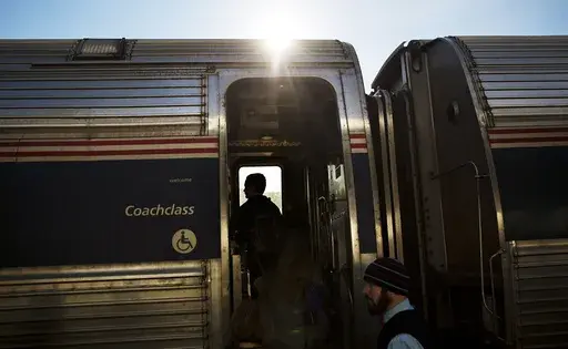 This file photo shows passengers boarding an Amtrak train heading to New Orleans from Atlanta on Nov. 23, 2016. Amtrak has a long-term plan to restore passenger service to Alabama, Mississippi and Louisiana for the first time since Hurricane Katrina in 2005. But much of Alabama's funding for the plan relies on the city of Mobile — and support among city council members there is wavering. (AP Photo/David Goldman, file)
